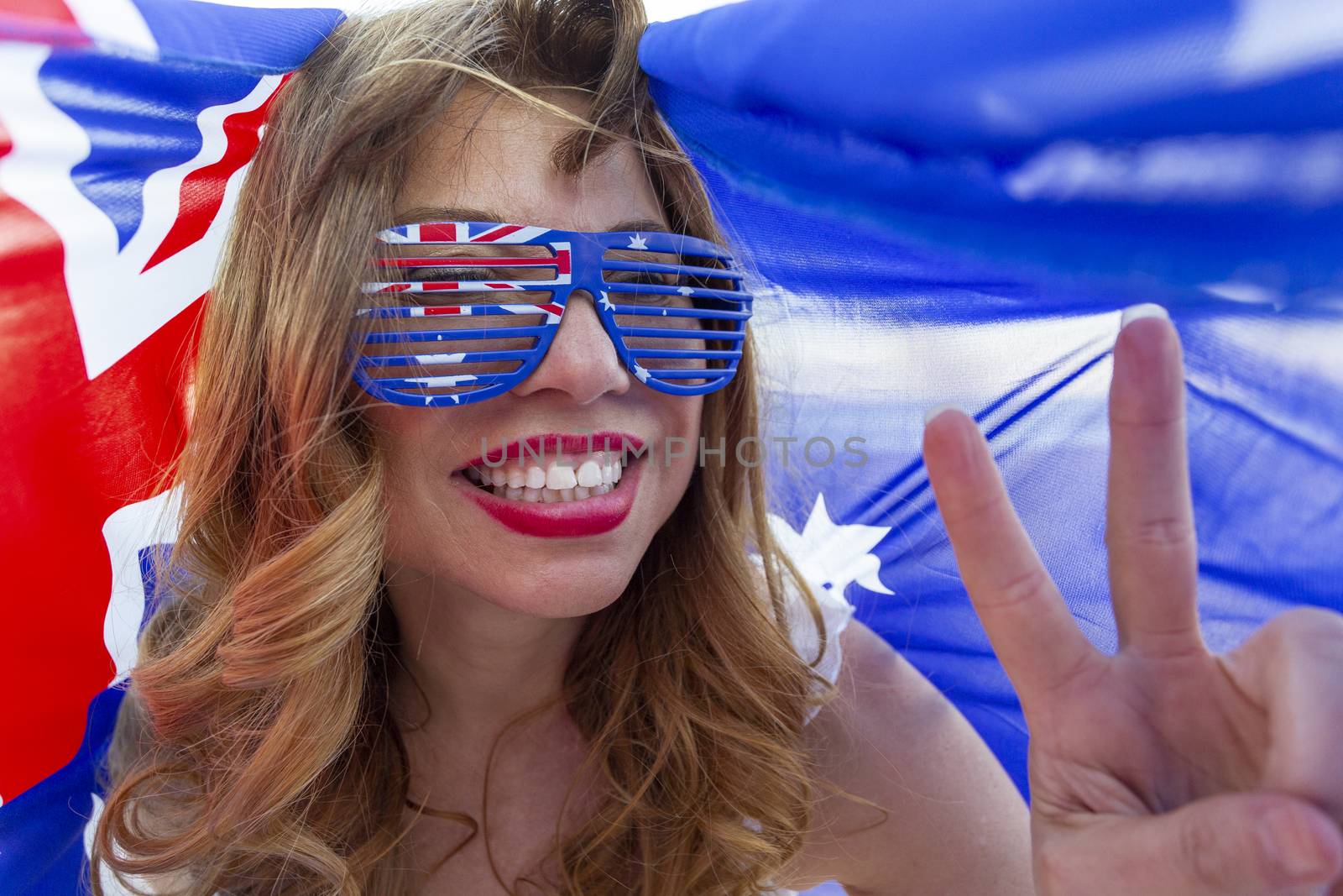 Patroitic multicultural woman celebrates with Australian flag
