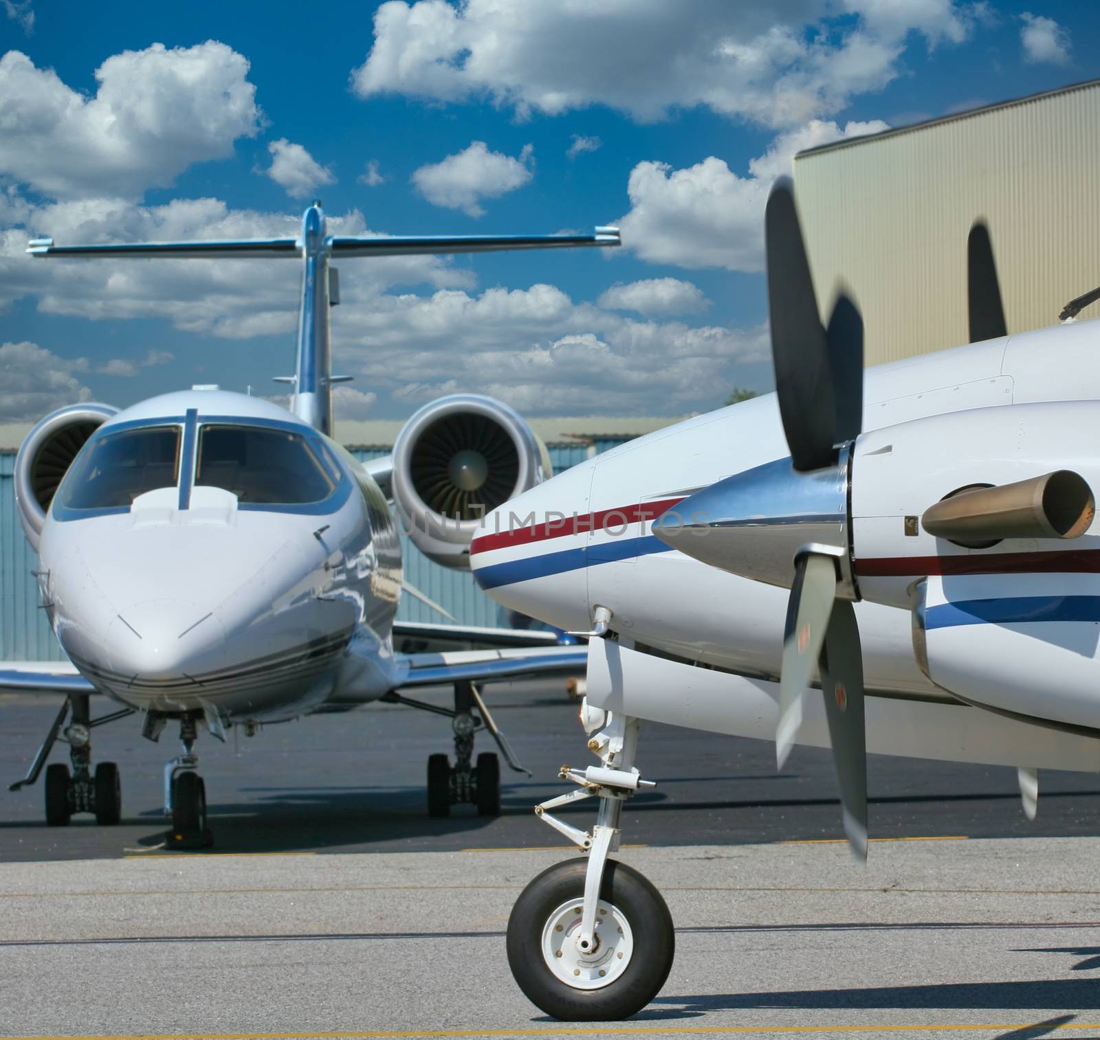 Propeller and jet driven airplanes at a small airport