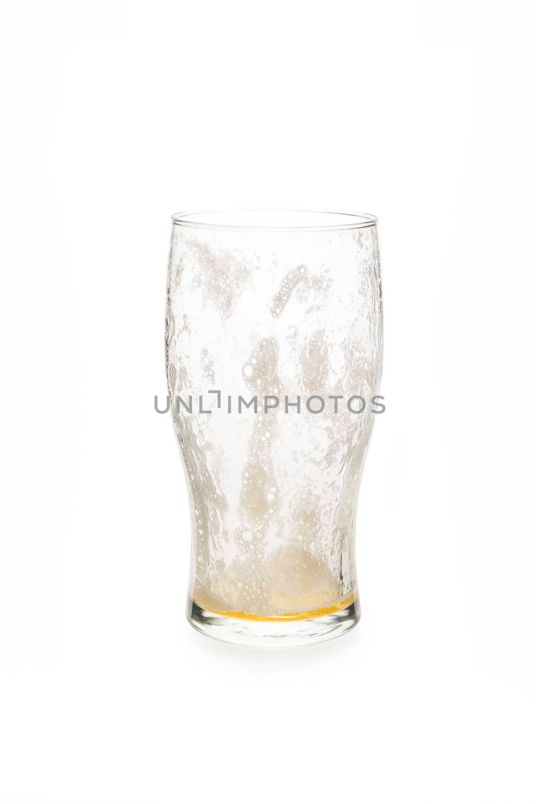 Empty pint glass with foam on the inside.