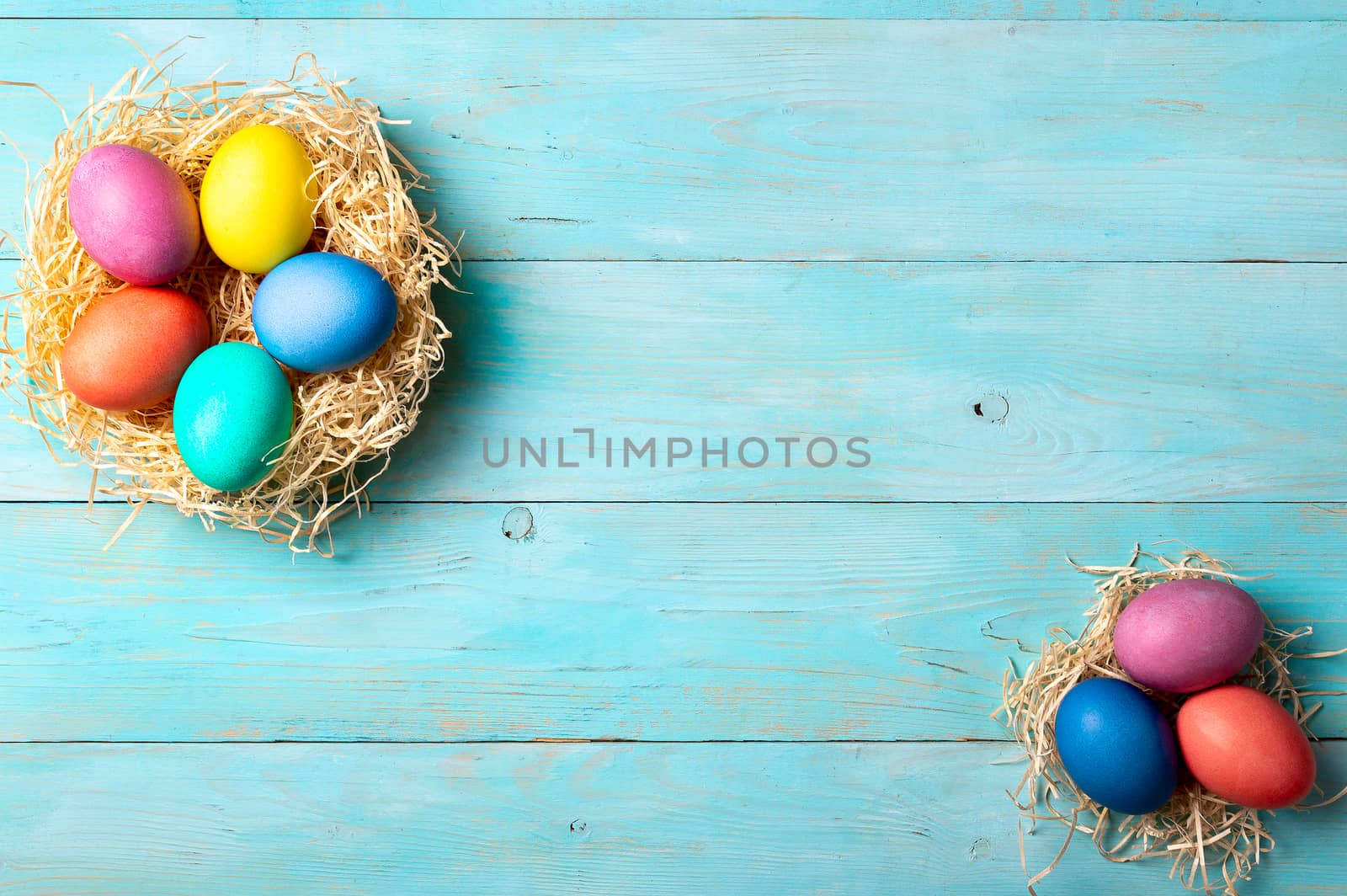 Easter concept. Colorful eggs on blue wooden background with copy space for text. Top down view or flat lay