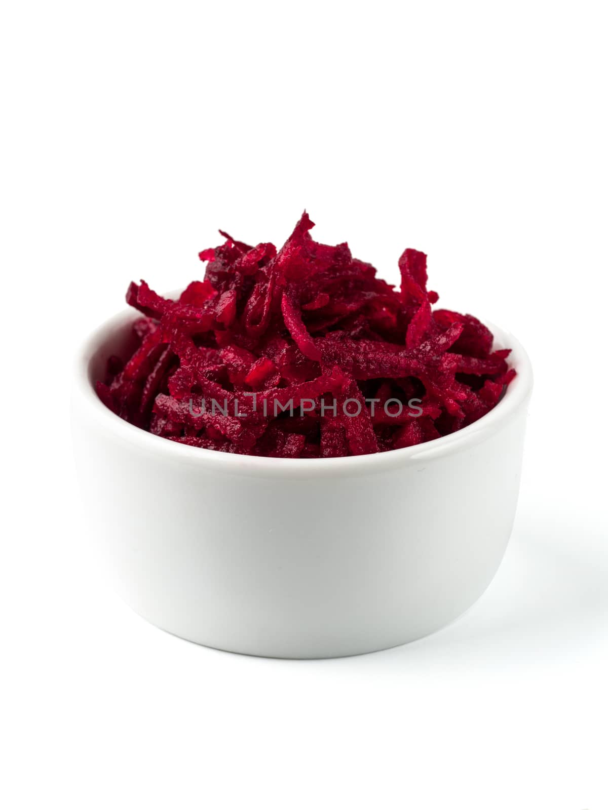 Grated beetroot in ceramic bowl. Shredded beet root salad isolated on white