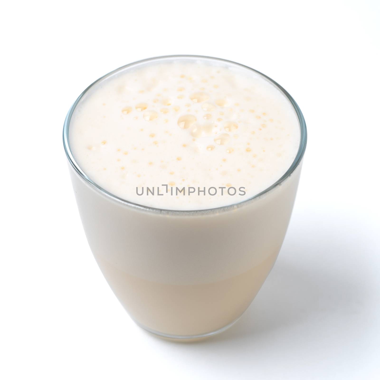 Vanilla milkshake with foam isolated on white by fascinadora