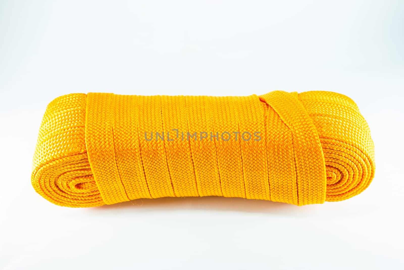 Orange rope rolls flat on white background.