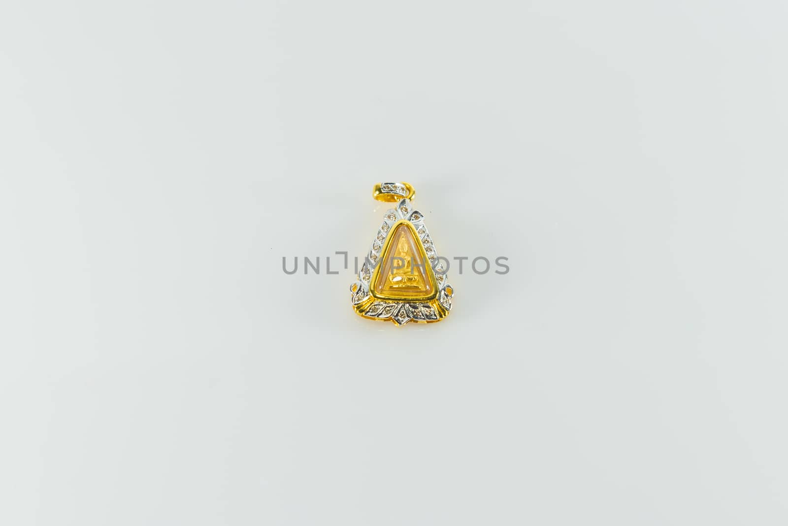 Amulet surrounded by diamonds on white background.