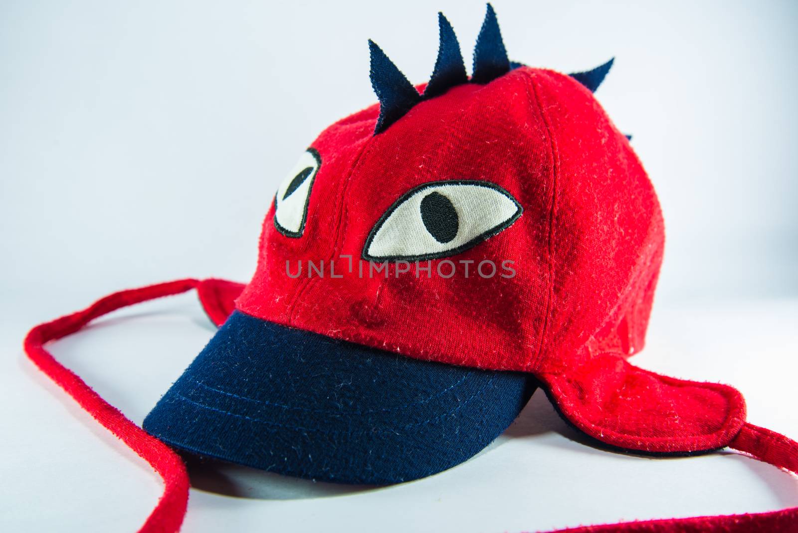 Red children cap on white background.