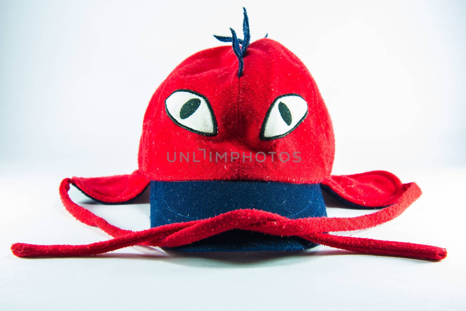 Red children cap on white background.