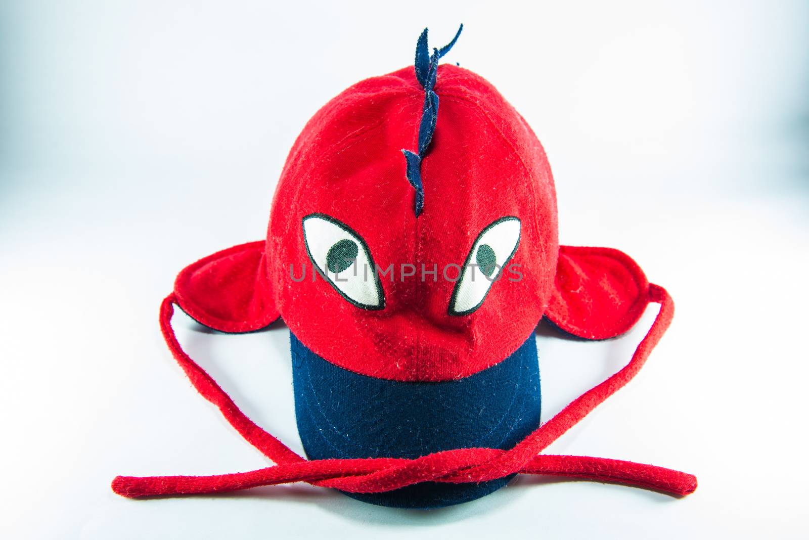 Red children cap on white background.