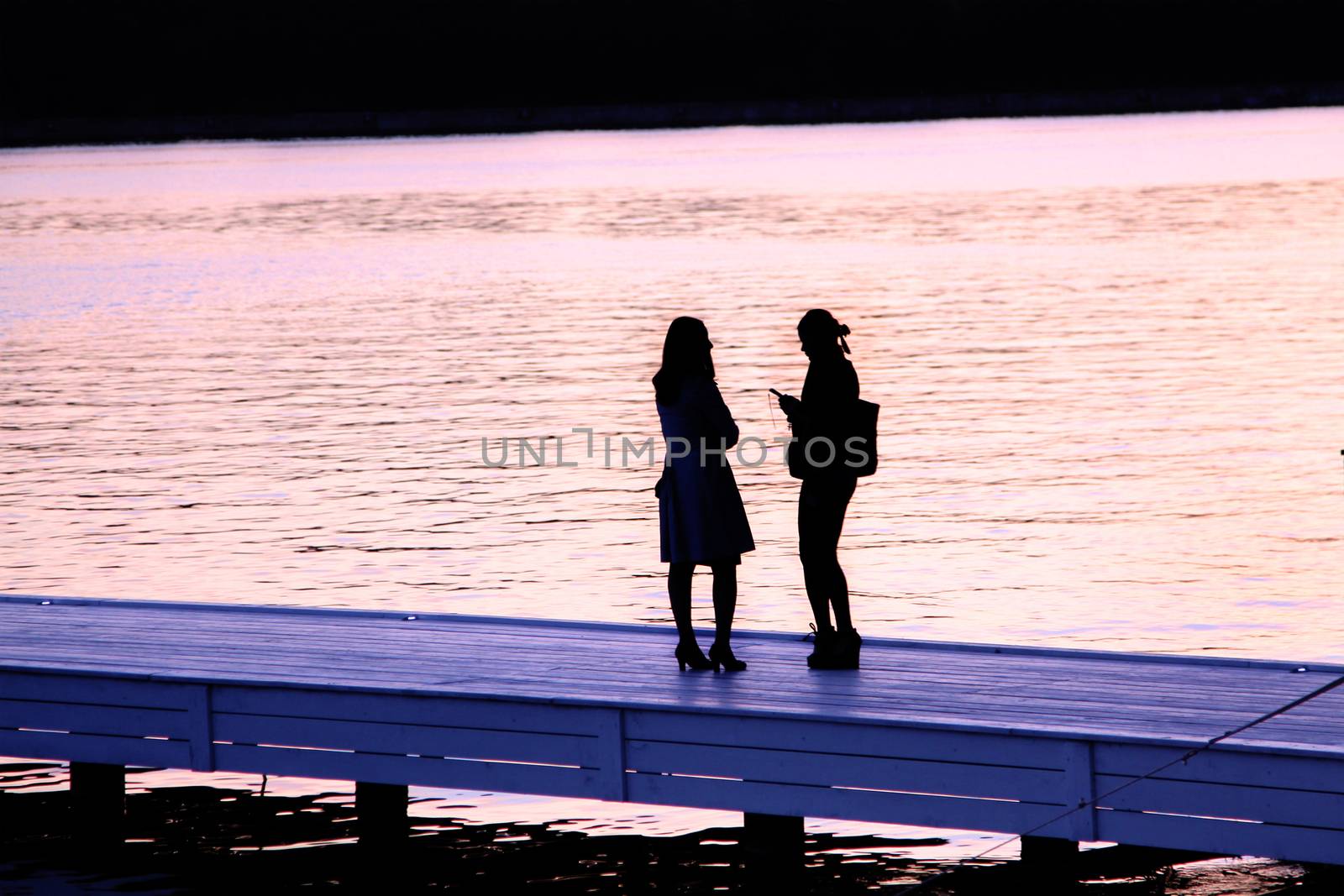 Two girls on the quay of the Moscow canal. by olga_zinovskaya