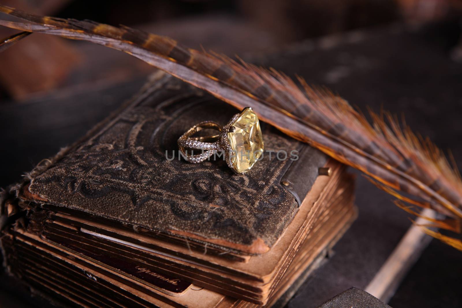 Fabulous background with the gold ring on an antique book by olga_zinovskaya