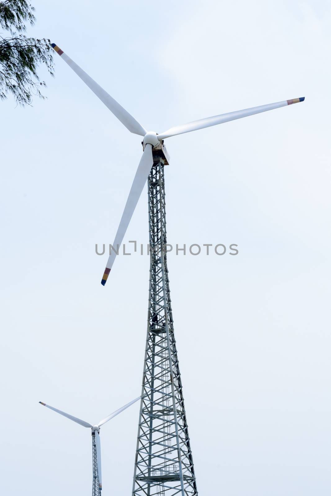 Taller hybrid tower lattice wind turbine build of rolled steel (tubular segmented) install high up 200 feet over land with 100m diameter rotor. Wind turbines widely used in renewable energy resource. In industry like roads, power collection network, substation, meteorology.