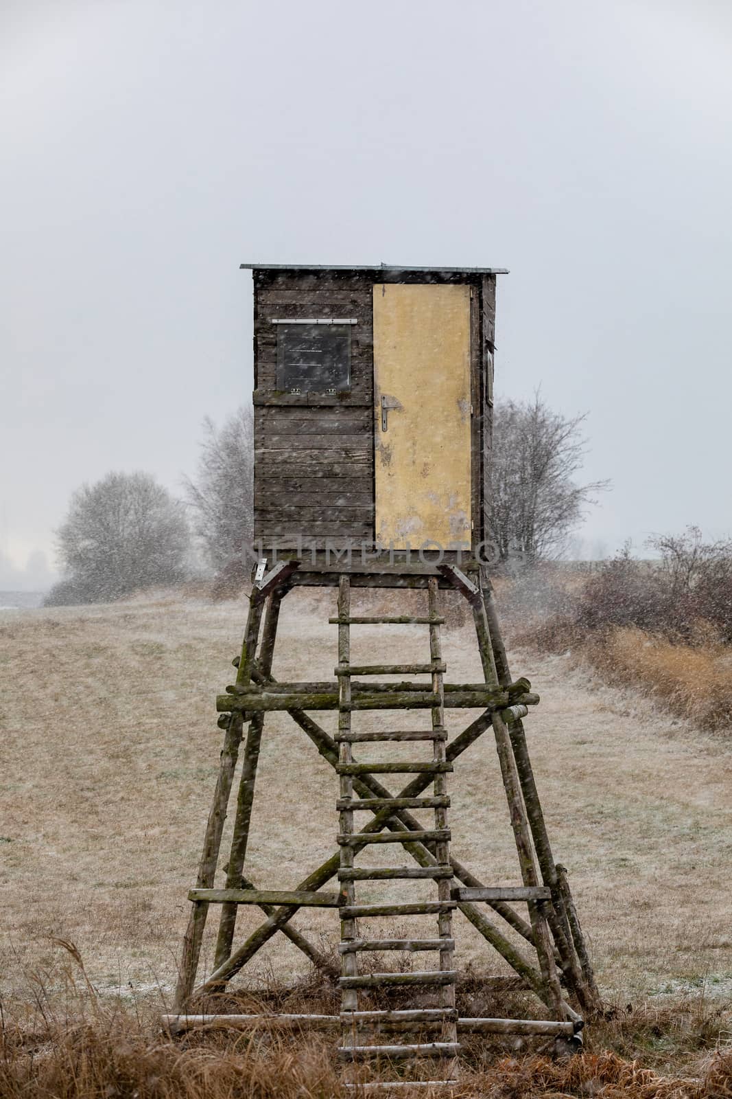 Wooden Hunters hunting tower in winter with snowfall, countryside landscape, Czech Republic, European Scenery