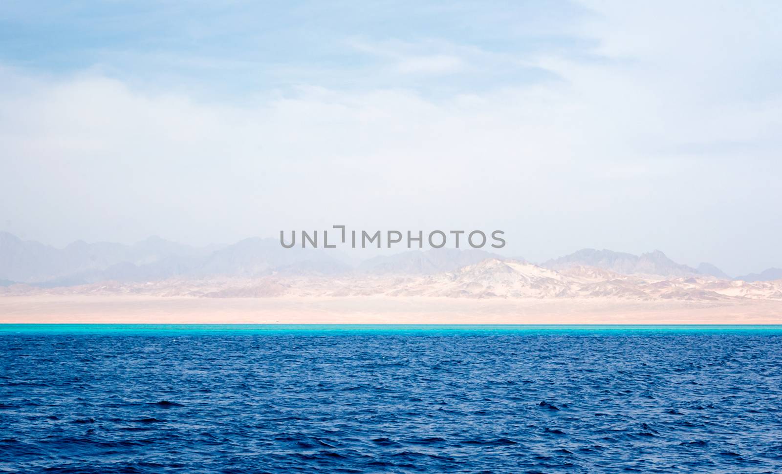 Red Sea landscape and coast with rocky mountains and a blue sky with clouds in Sharm El Sheikh Egypt