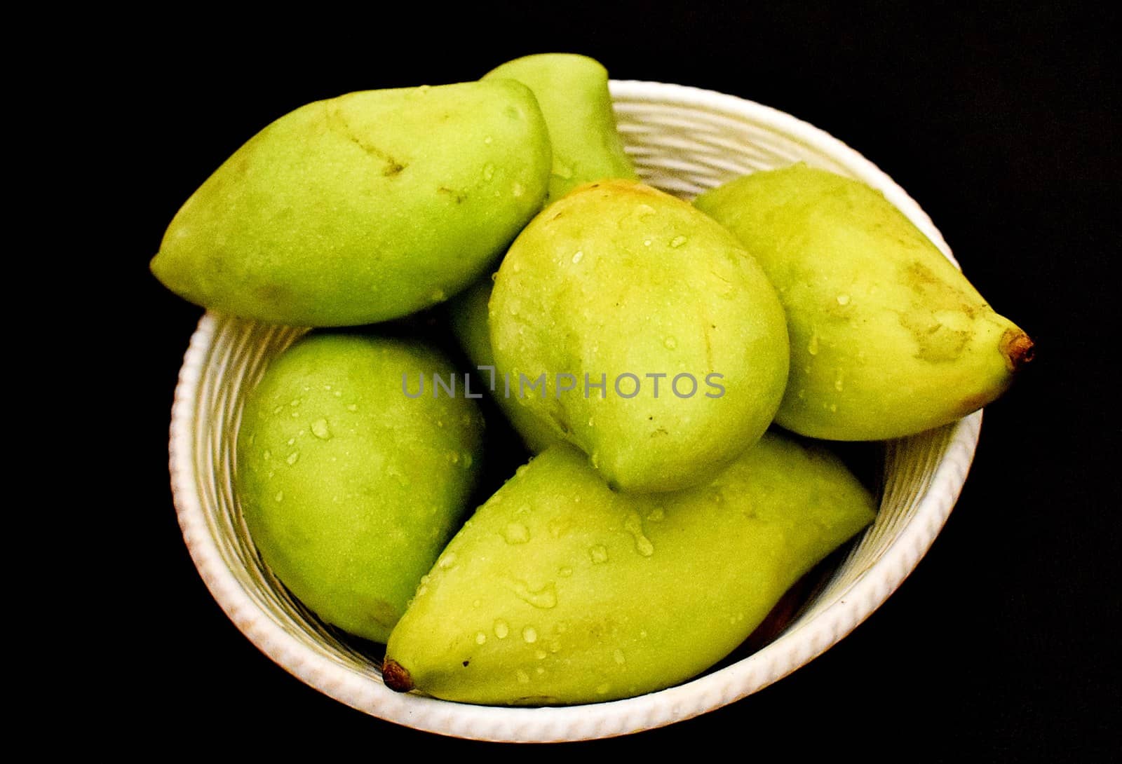 Green mangoes in a Basket