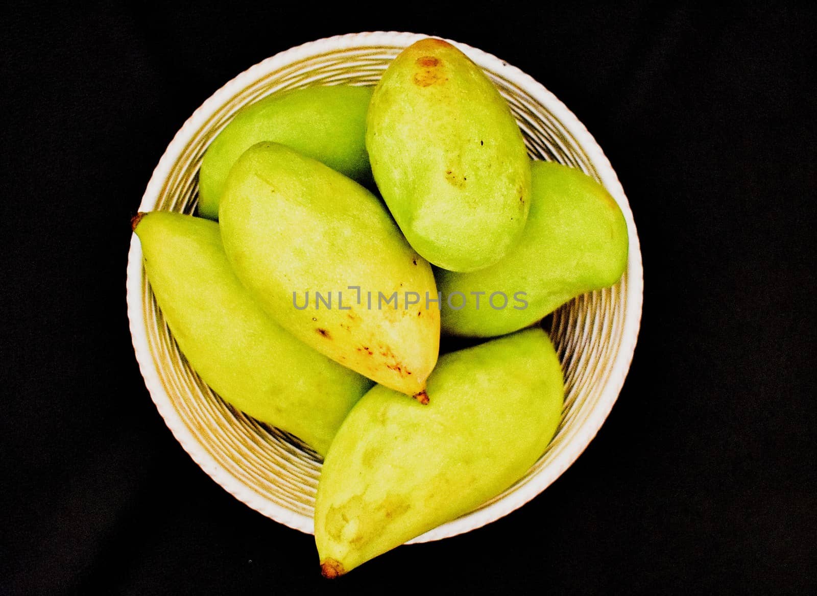 Green mangoes in a Basket