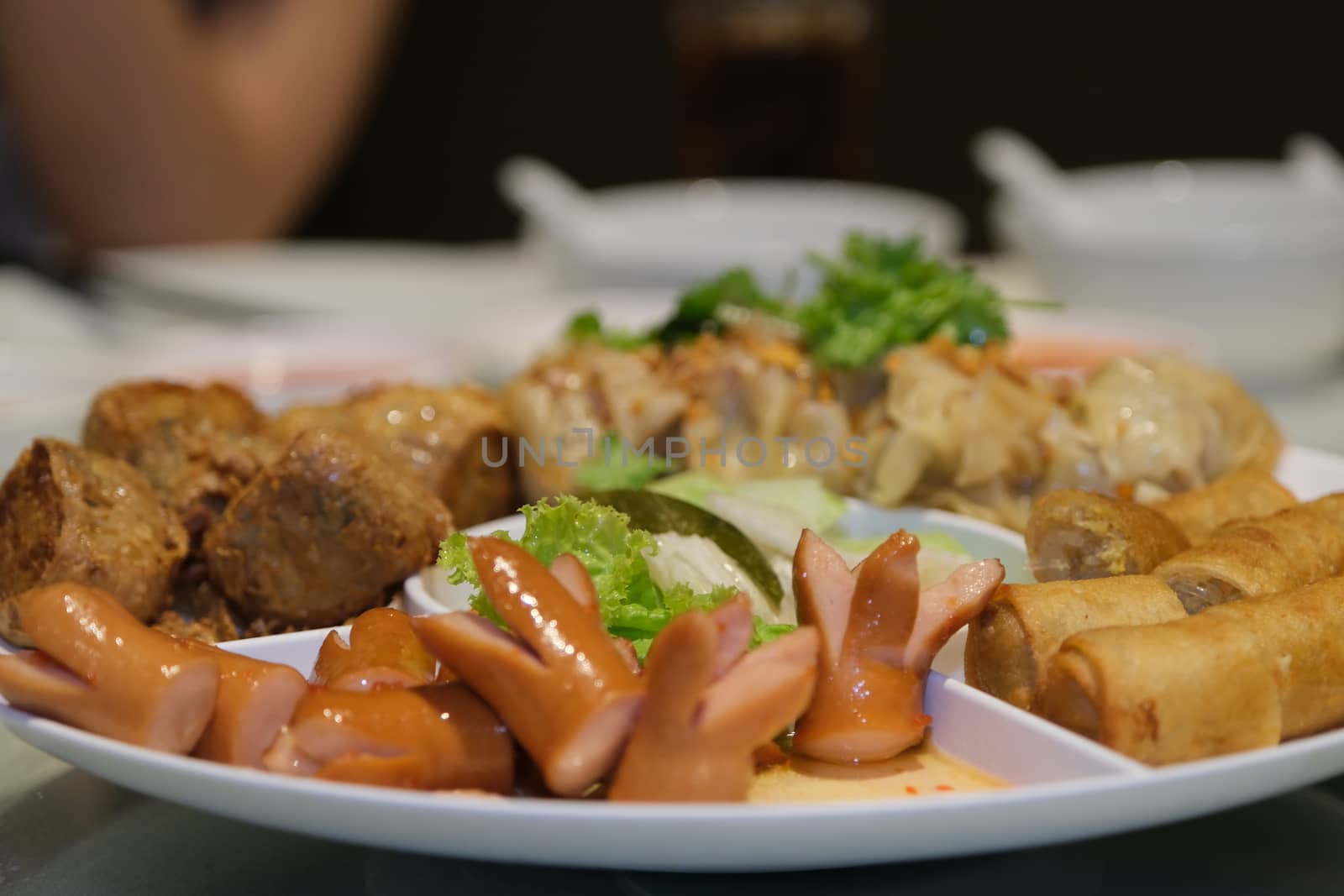 The Sliced on a plate in the form of ham sausage and vegetables in a restaurant, appetizer, Selected focus