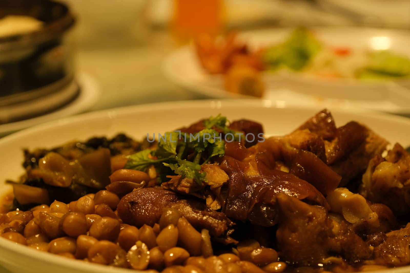 The Beef stew with potatoes, carrots and herbs on black background with copy space, side view