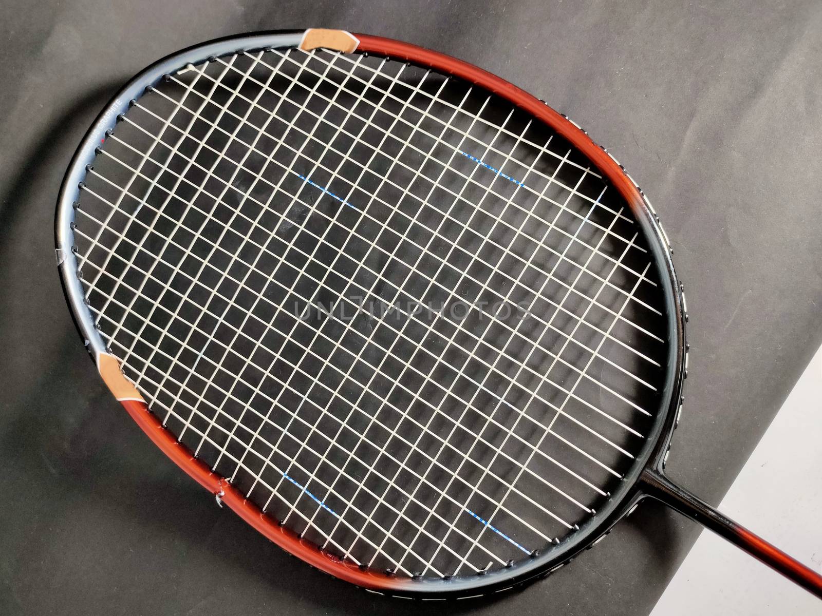 A Broken badminton racket on black background