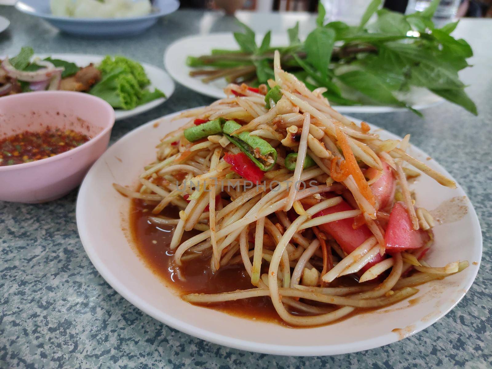 Famous Thai food, papaya salad or what we called "Somtum" in Thai, Side view by peerapixs