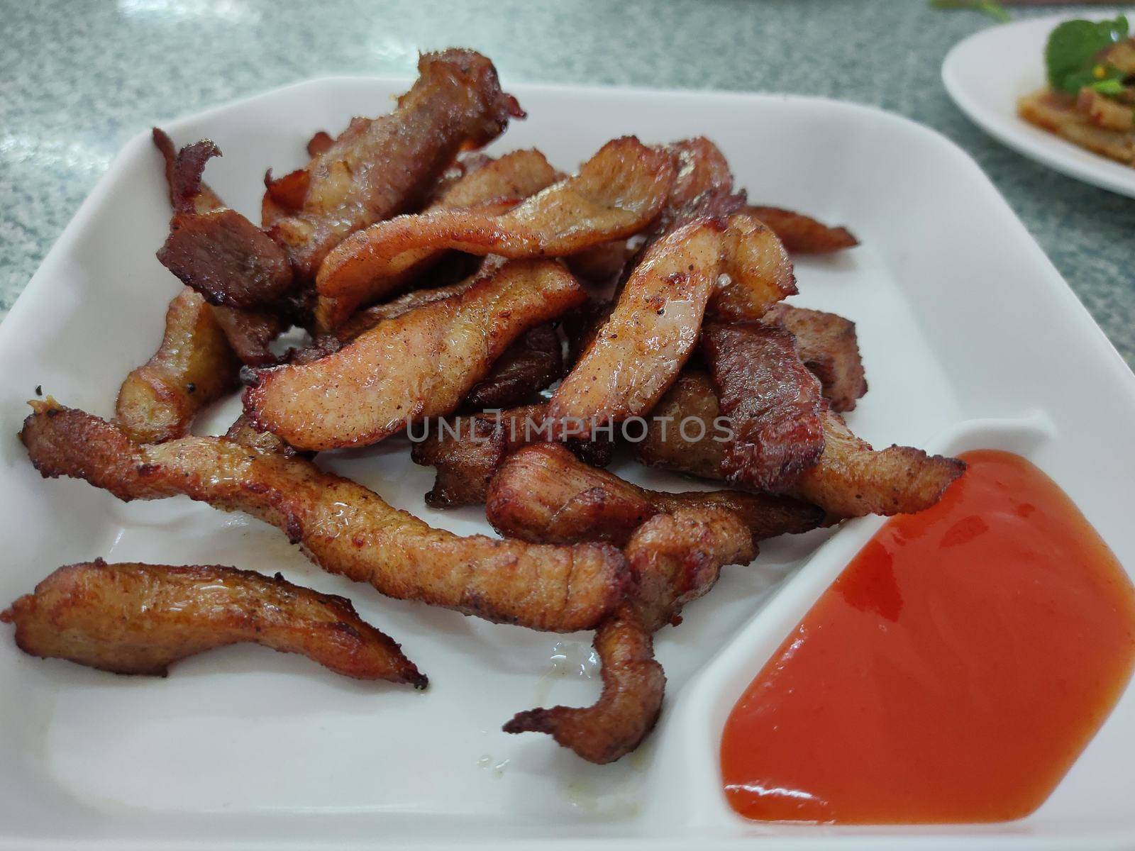 Food deep fried dried pork. Local appetizer food in Thailand for breakfast or lunch. by peerapixs