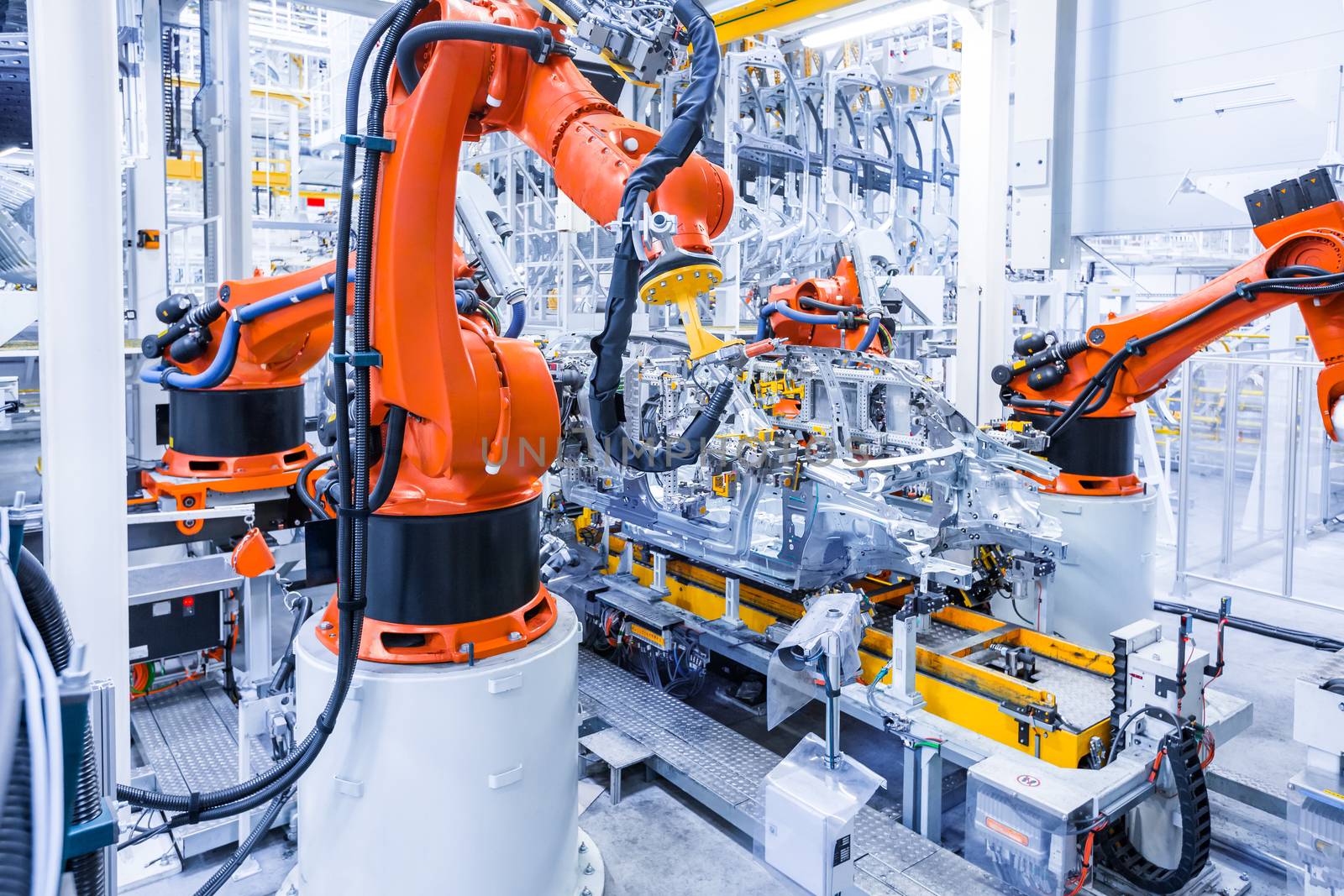 robotic arms in a car plant