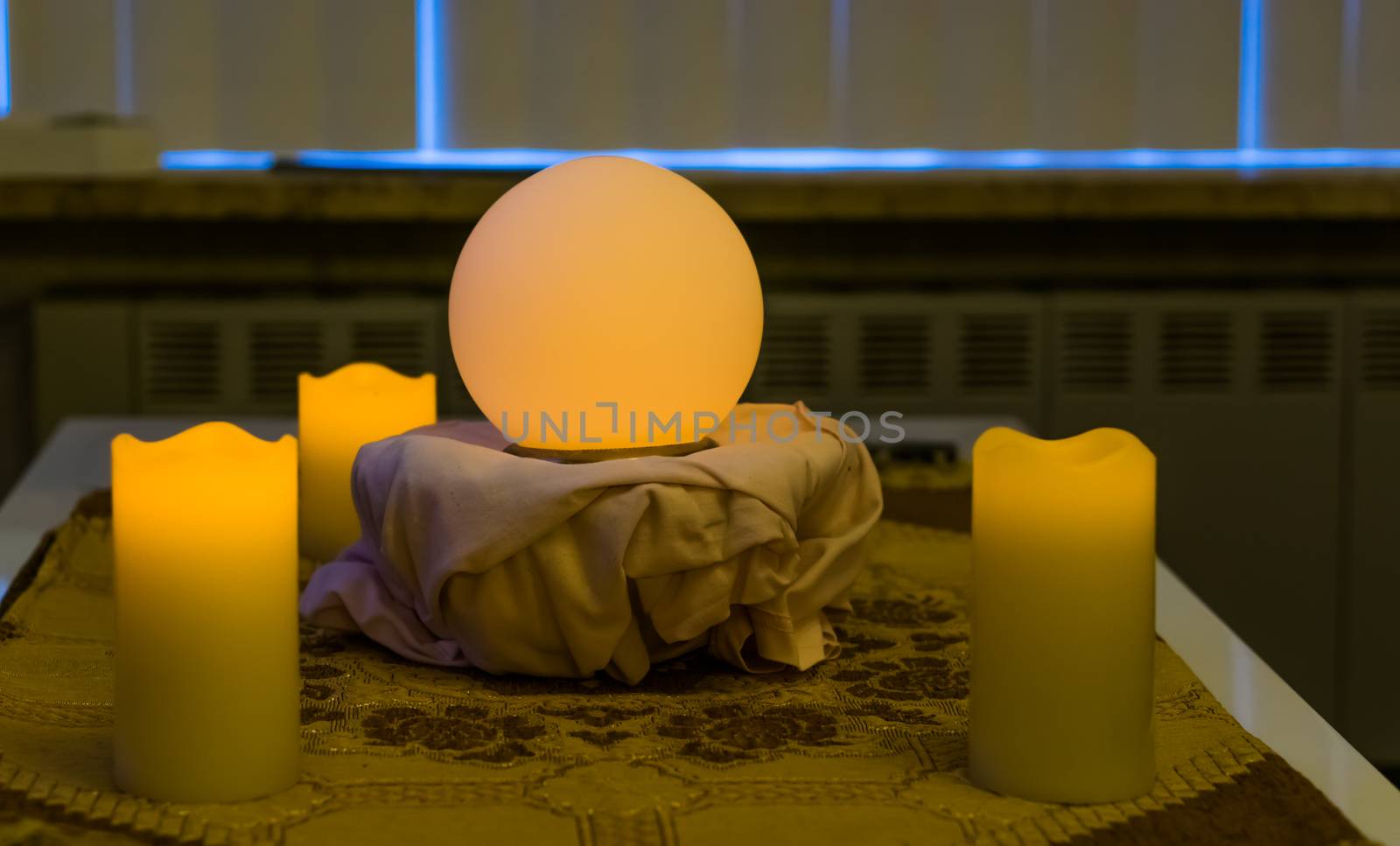 glowing fortune teller sphere with lighted candles, spiritual and witchcraft background by charlottebleijenberg