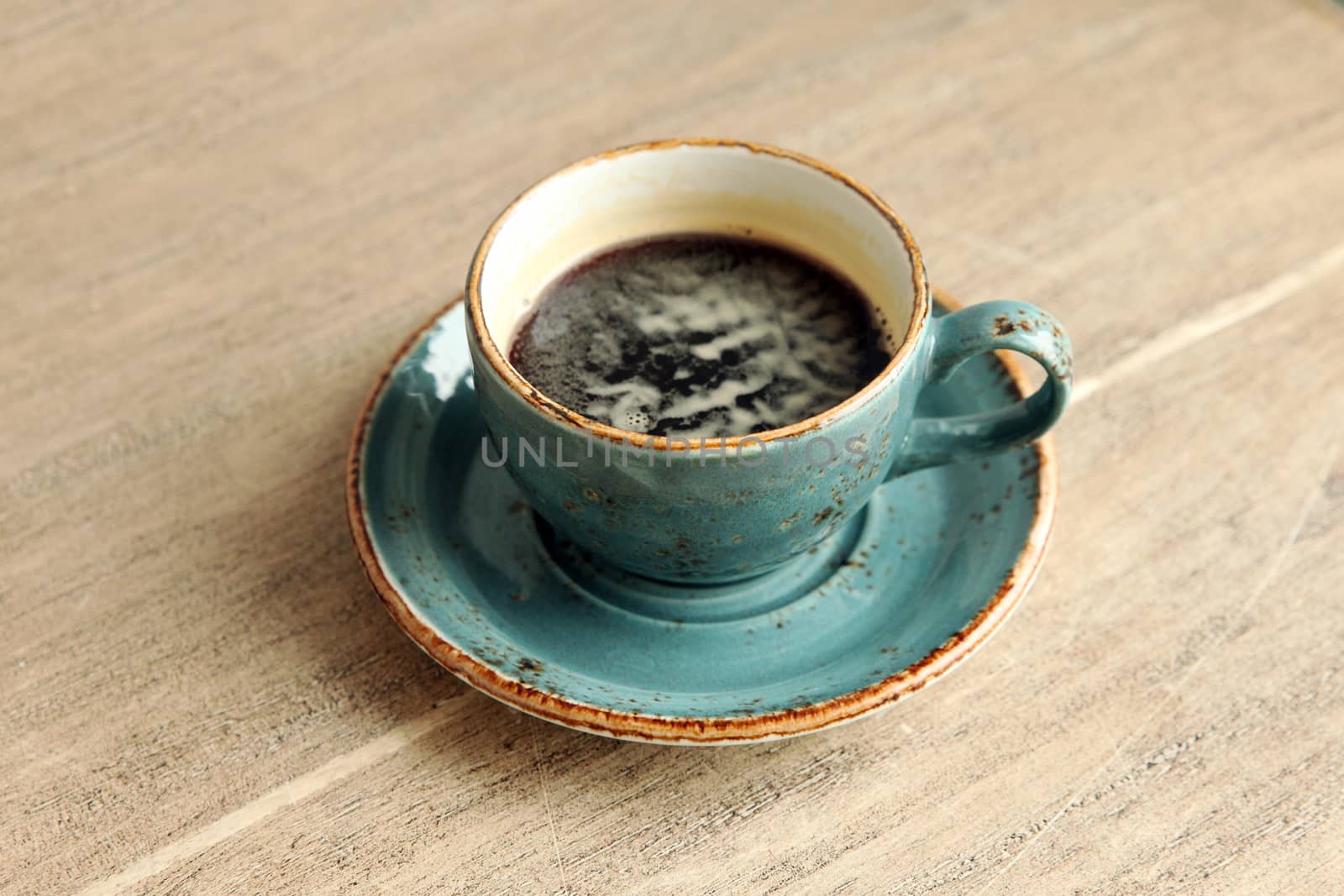 Cup of coffee on the table by olga_zinovskaya