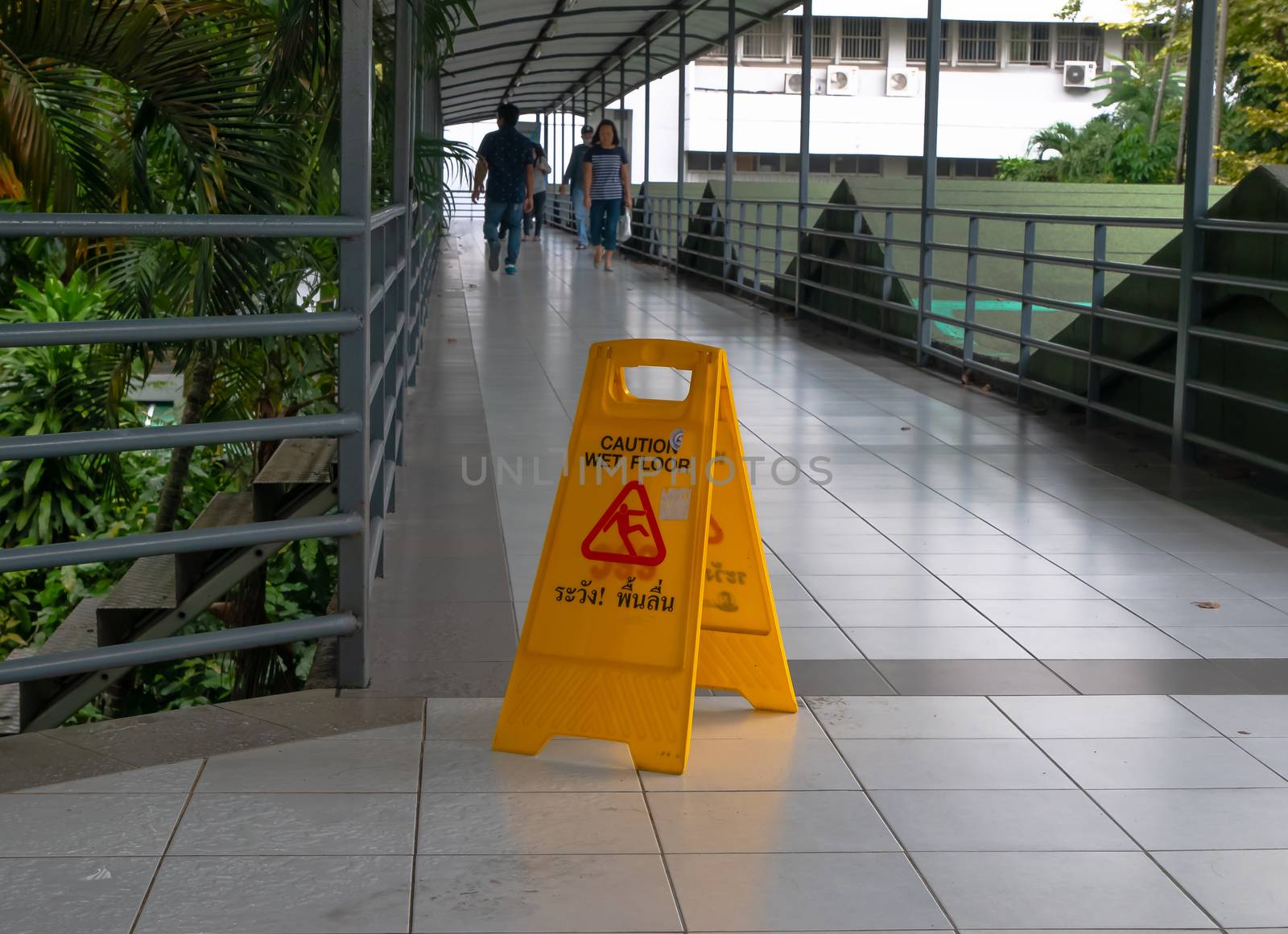 Janitor Mopping With Wet Floor Sign In walk way