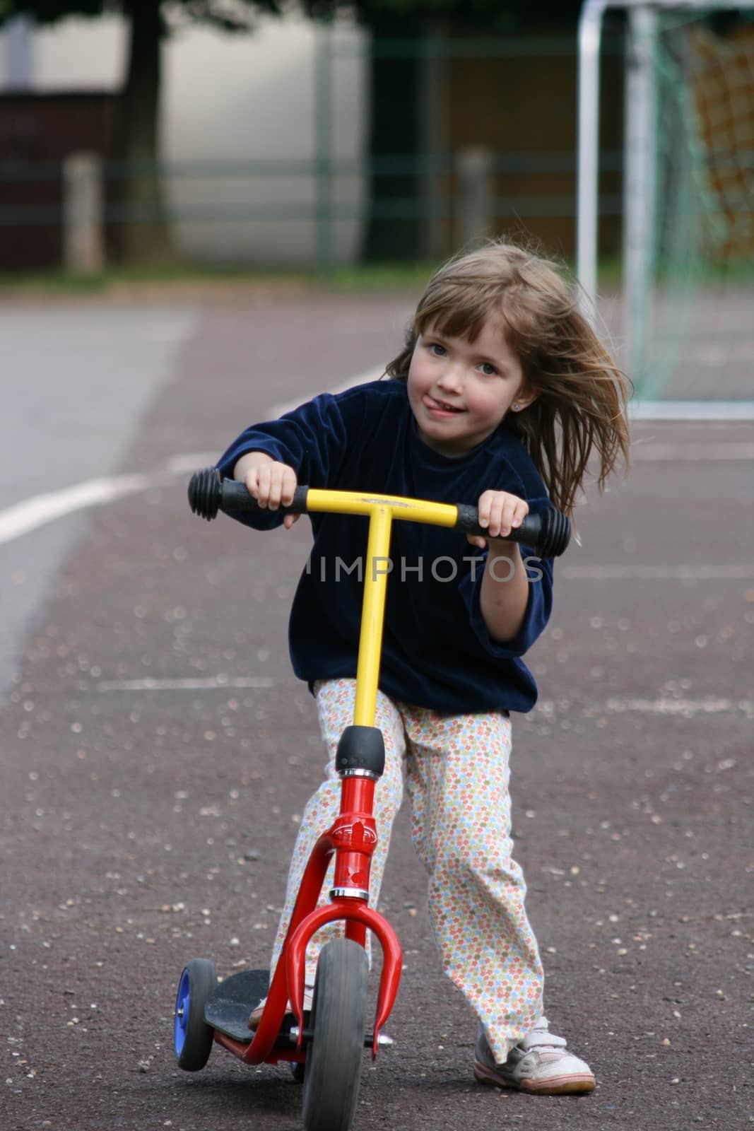 blond girl has fun driving the scooters