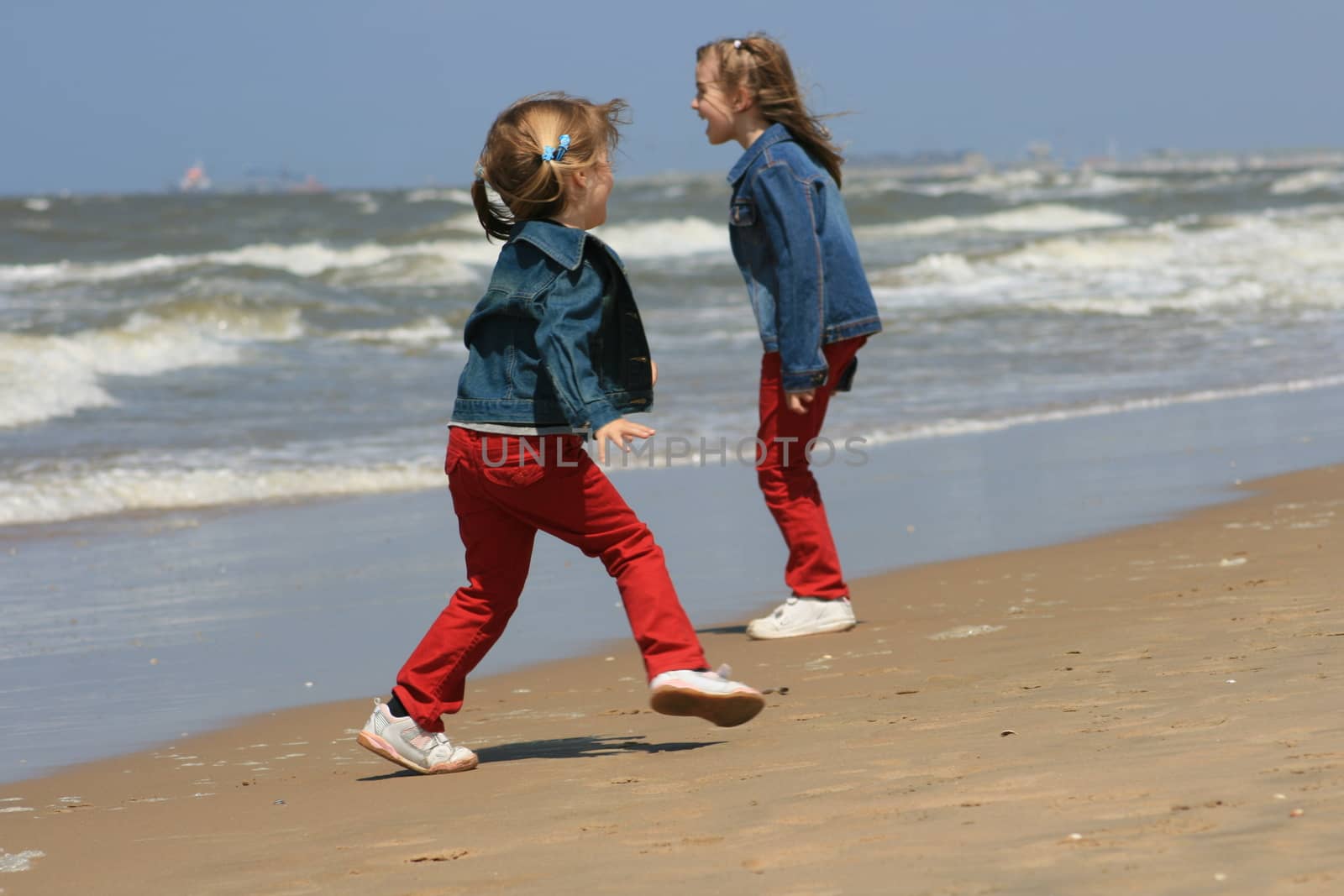 two blonde sisters on the beach