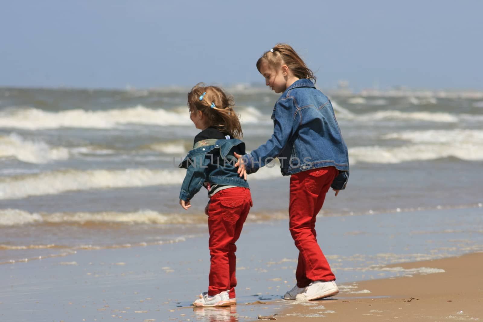 two blonde sisters on the beach