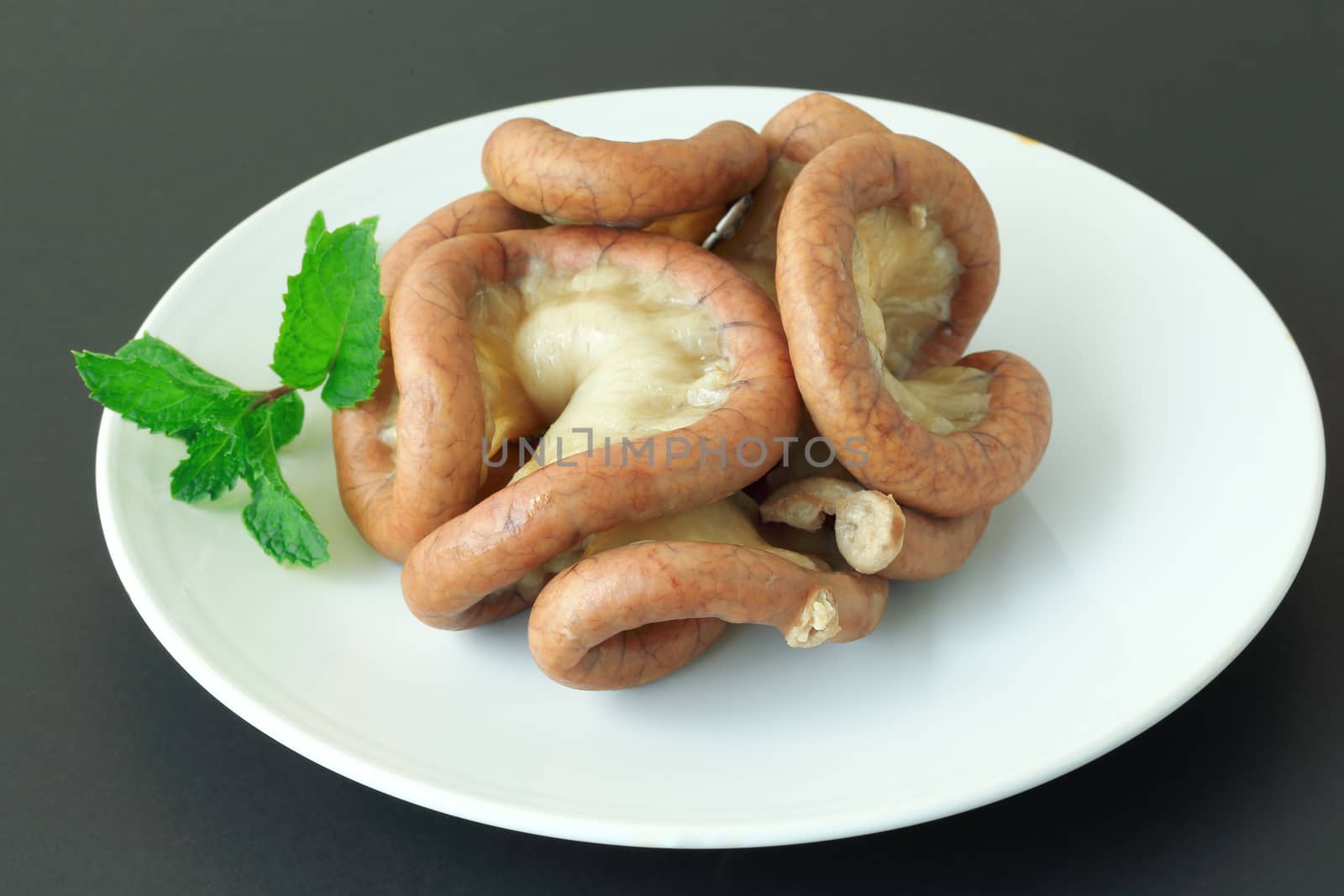 Boiled chitterlings internal organs of pig on gray background.