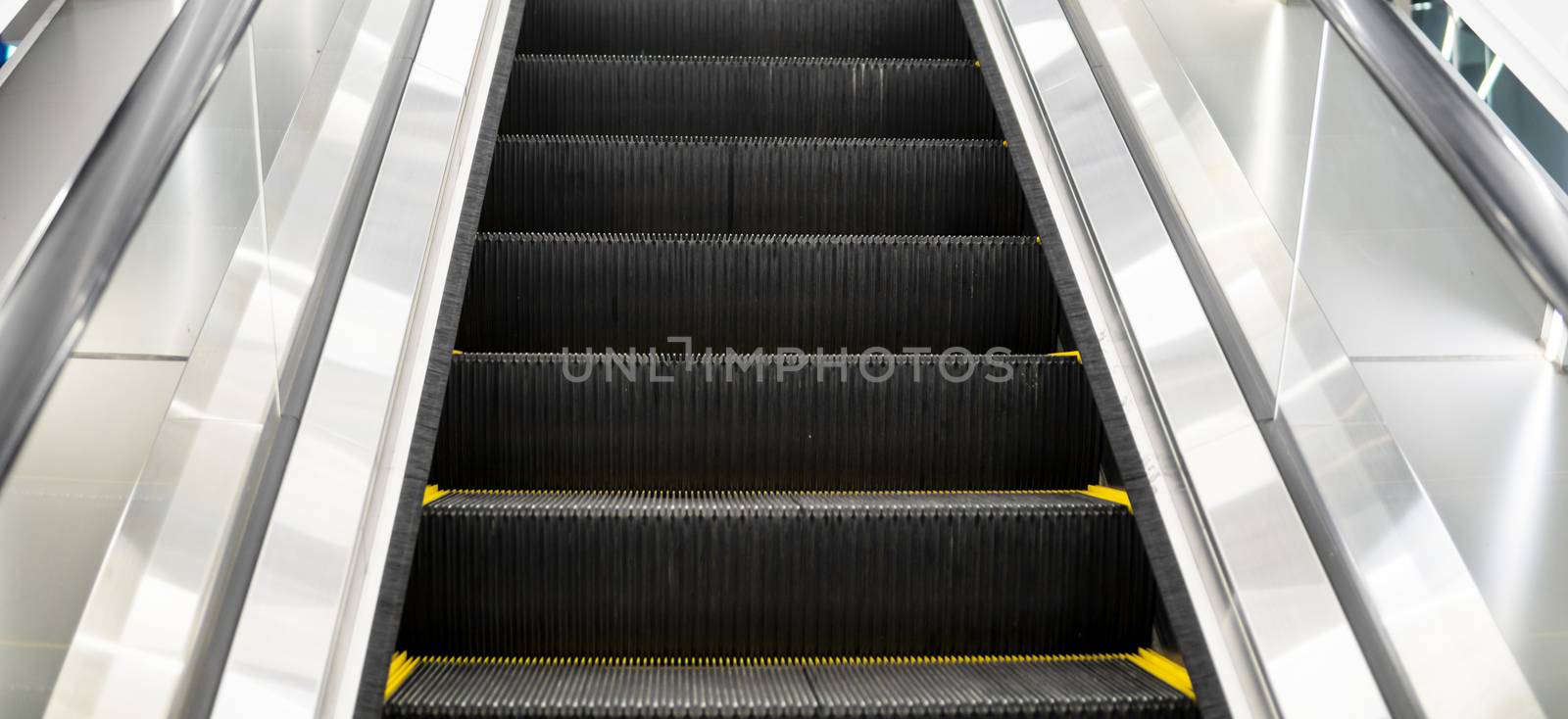 Ditry stairs on Escalator with yellow strips. by vovsht