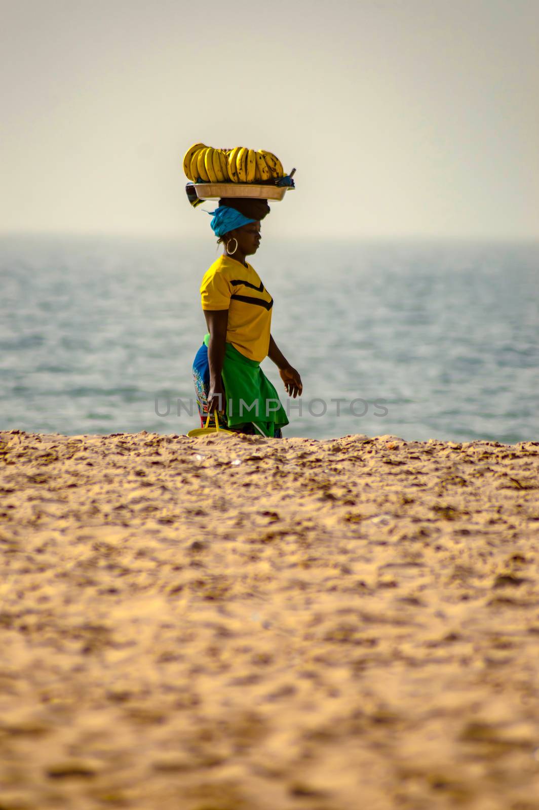 GAMBIE, BIJILO - 05 January 2020;Woman selling fruit in a basket on Bijilo beach in
Gambia