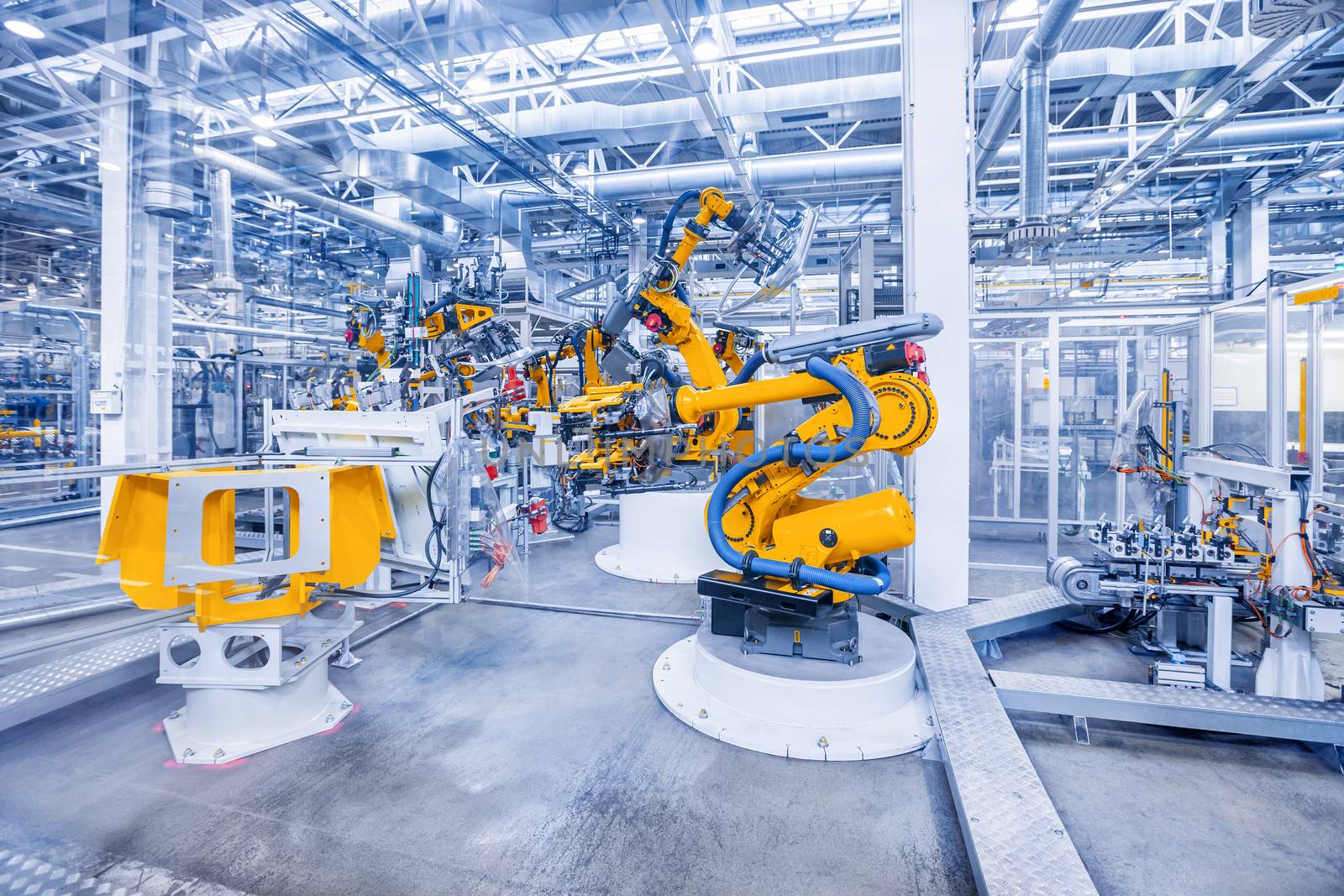 robotic arms in a car plant