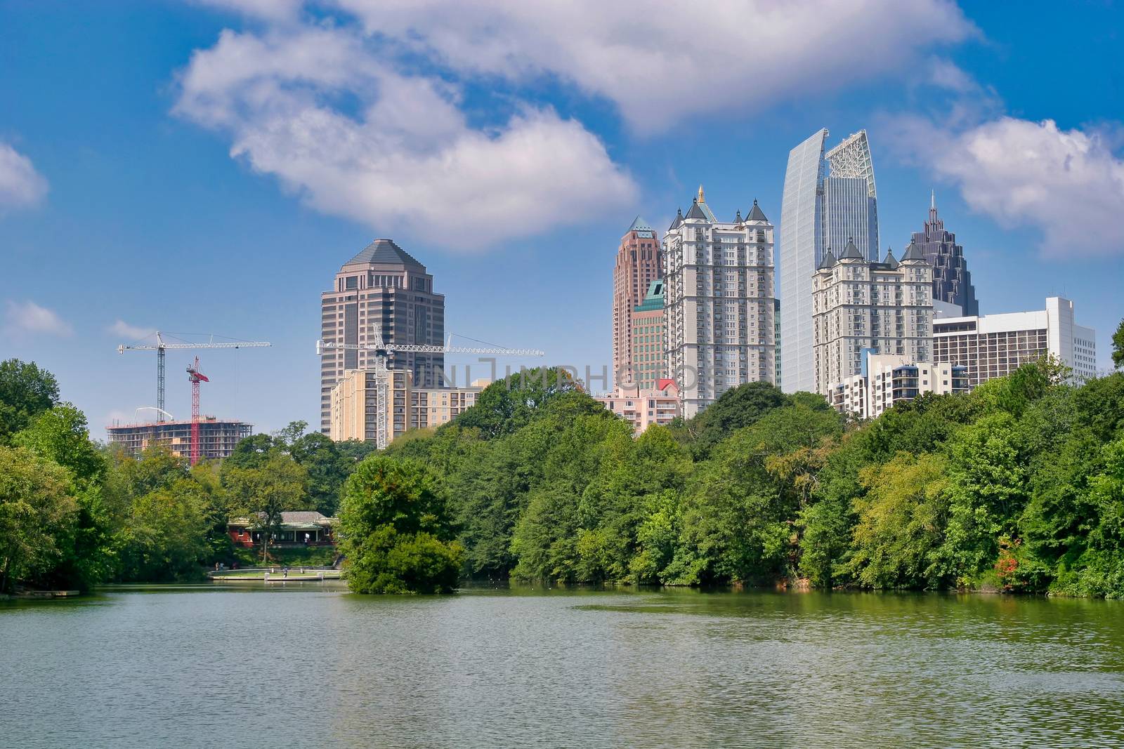 A city skyline beyond a lake in the park