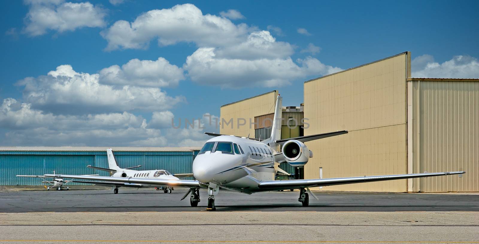 A small private white jet at an airport