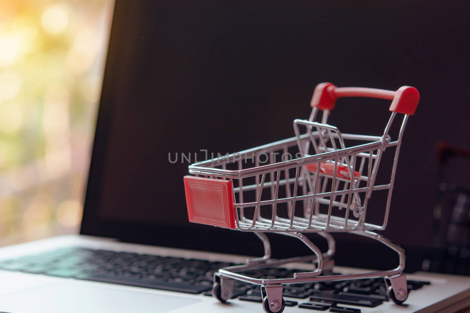 Shopping online concept - Empty shopping cart or trolley on a laptop keyboard. Shopping service on The online web. offers home delivery.
