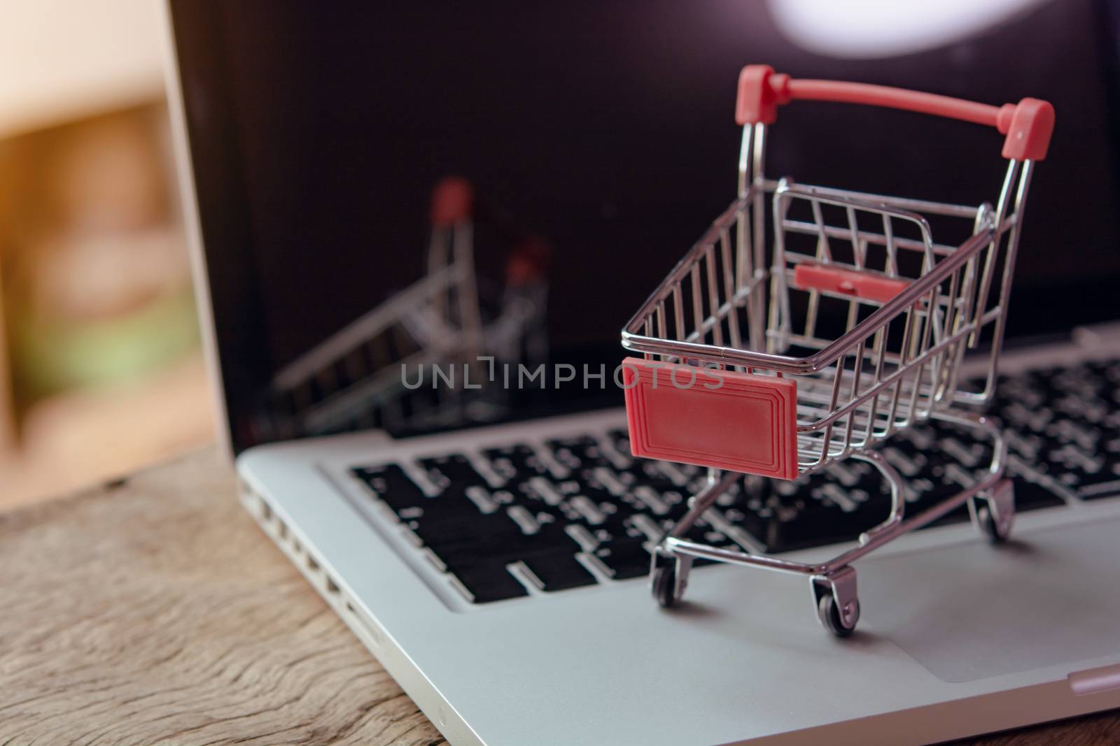 Shopping online concept - Empty shopping cart or trolley on a laptop keyboard. Shopping service on The online web. offers home delivery.
