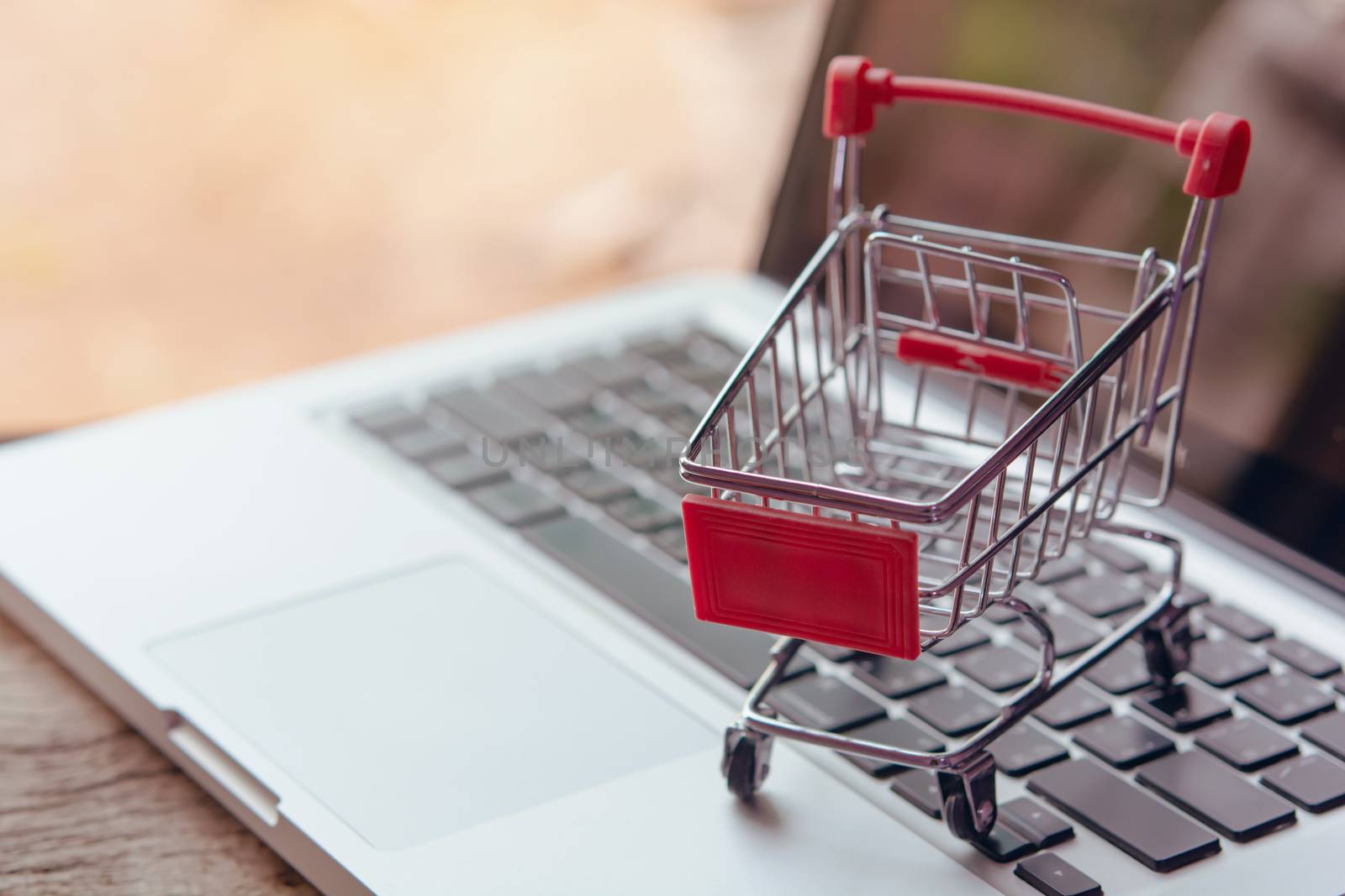 Shopping online concept - Empty shopping cart or trolley on a laptop keyboard. Shopping service on The online web. offers home delivery.
