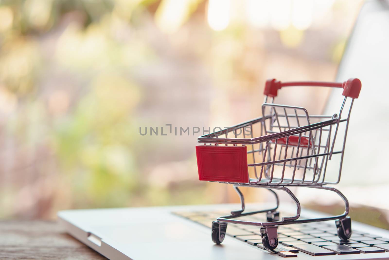 Shopping online concept - Empty shopping cart or trolley on a laptop keyboard. Shopping service on The online web. offers home delivery.
