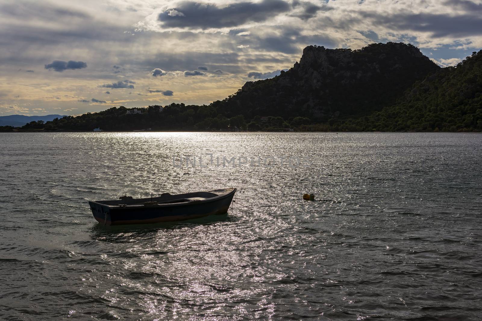 Small boat in Vouliagmeni lake near Loutraki, Greece by ankarb