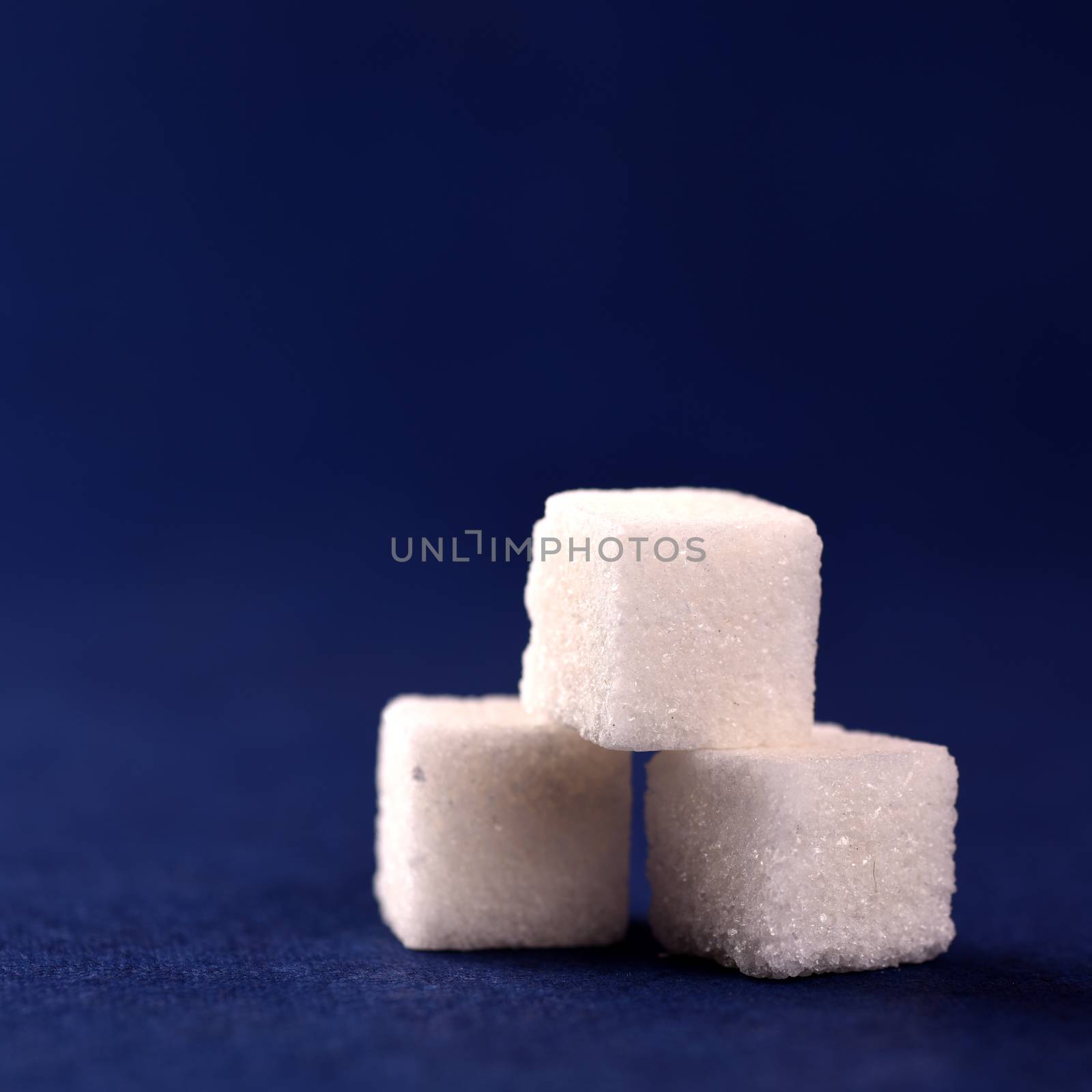 Close-up of Sugar Cubes on Blue Background