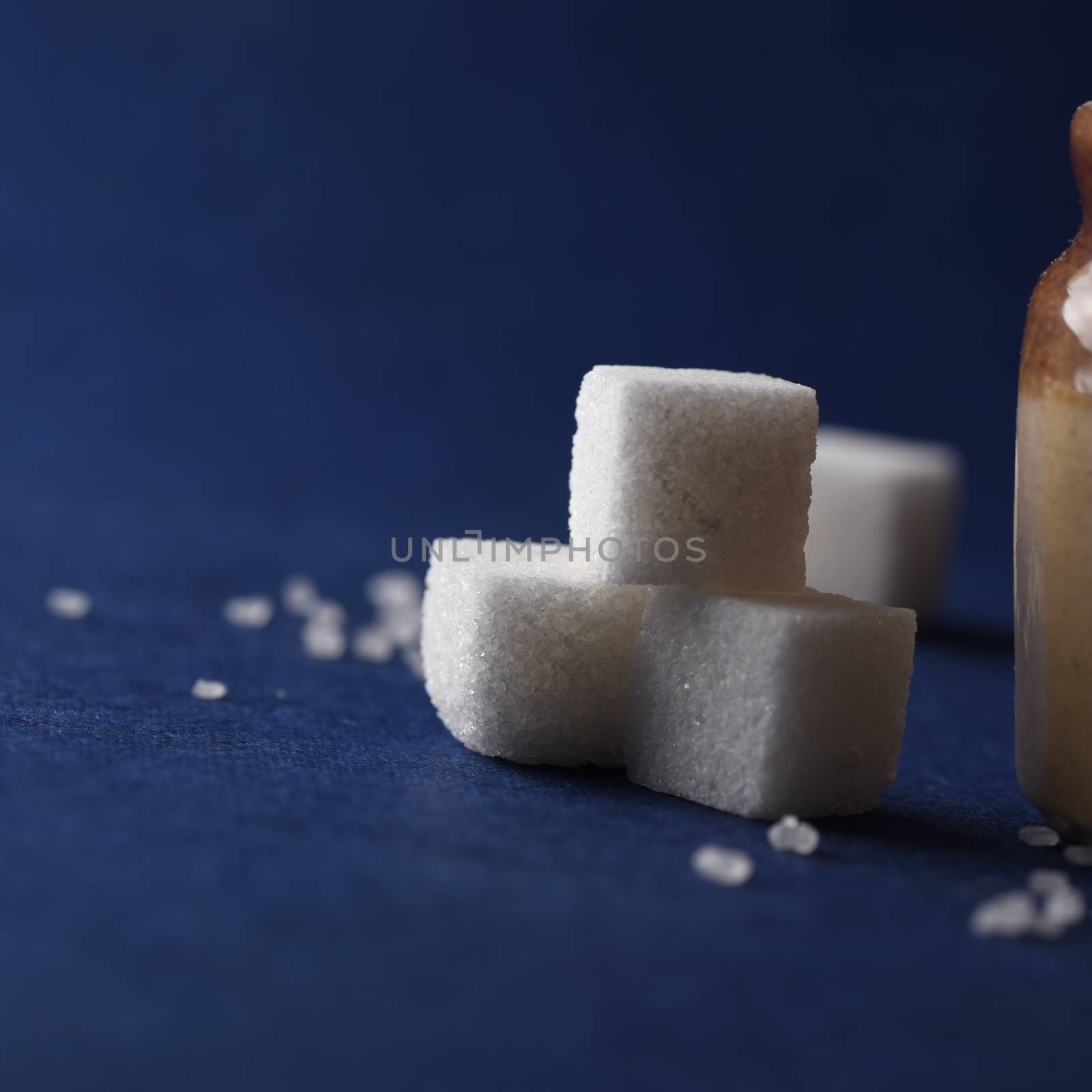 Sugar. white granulated sugar and refined sugar on a blue background