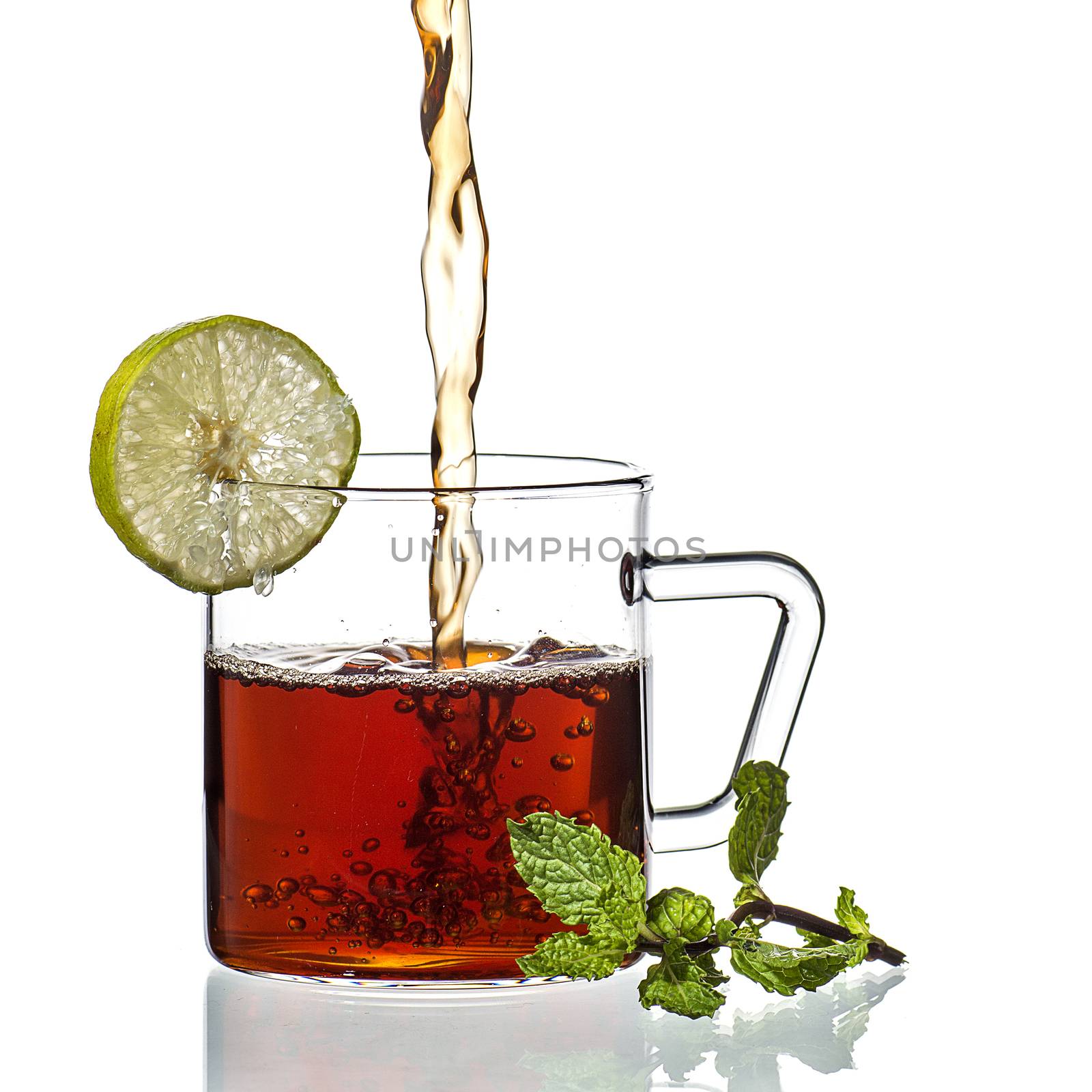 Cup of tea, mint and lemon on white background