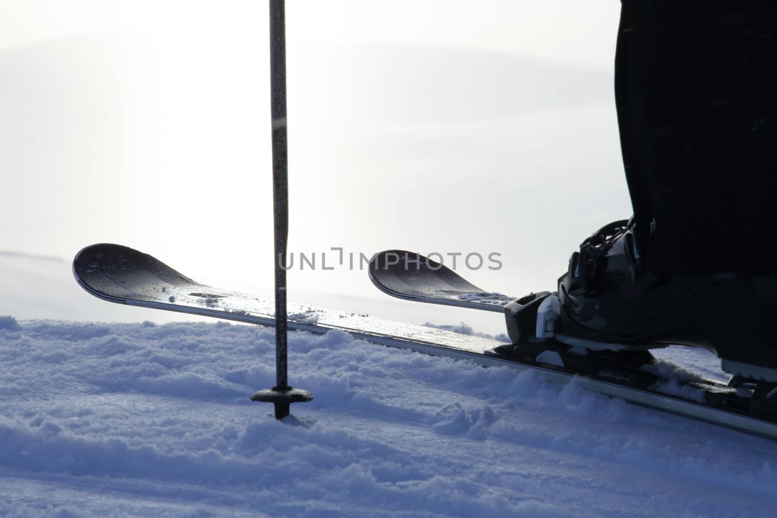 Skier on ski slope with mountains in background