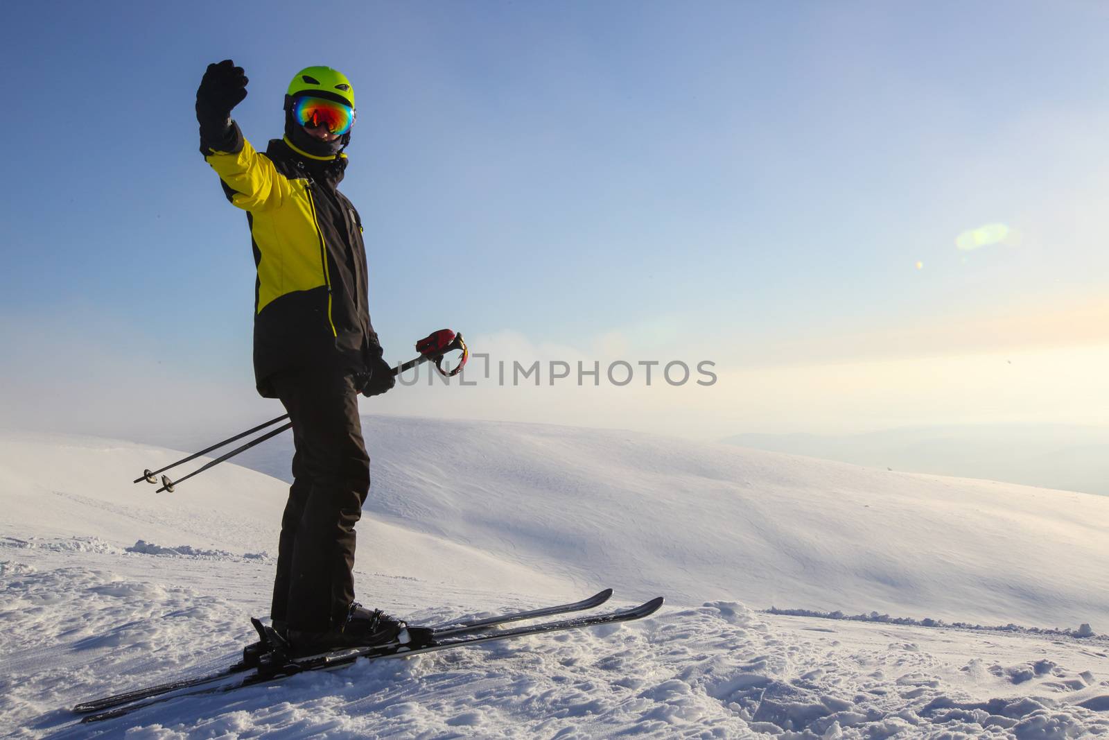 Skier on ski slope with mountains in background