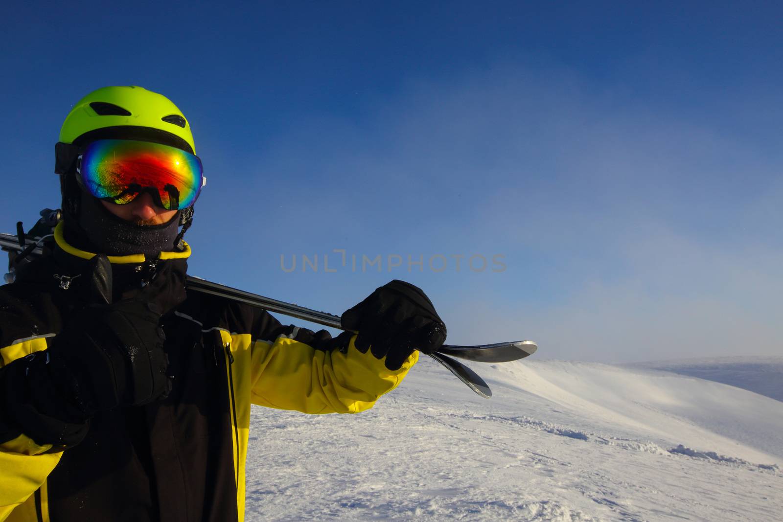 skier on a peak by destillat