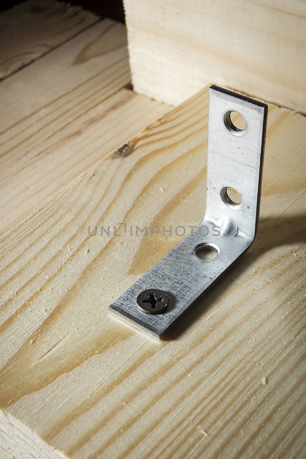 Metal corners and screws for fixing wooden boards