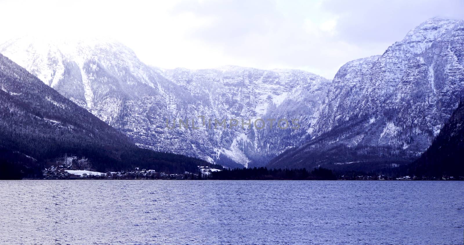 Panorama of Hallstatt lake outdoor with snow mountain background blue tone in Austria in Austrian alps by polarbearstudio