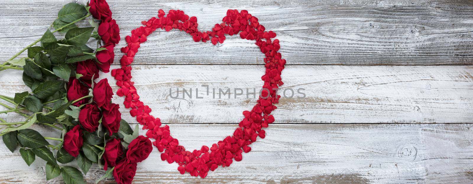 Happy Valentines Day with tiny hearts and red roses on white rustic wood    